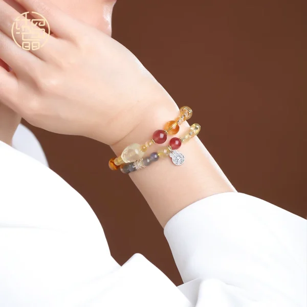 Double wrap yellow crystal bracelet worn on wrist