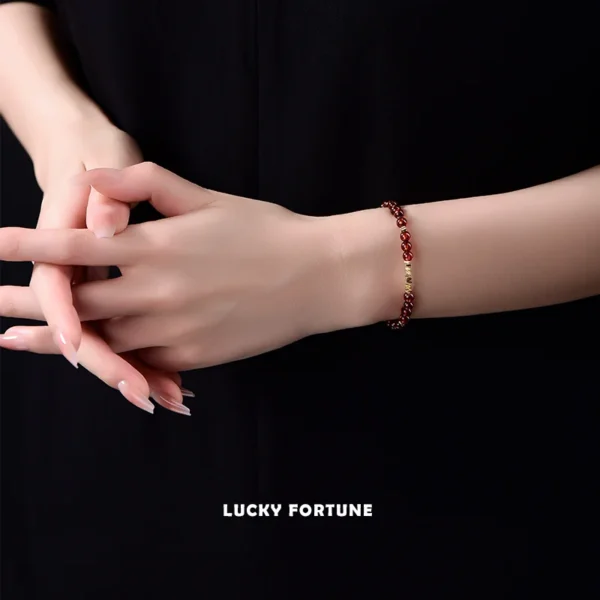 Woman Wearing Garnet Bracelet in Red Outfit