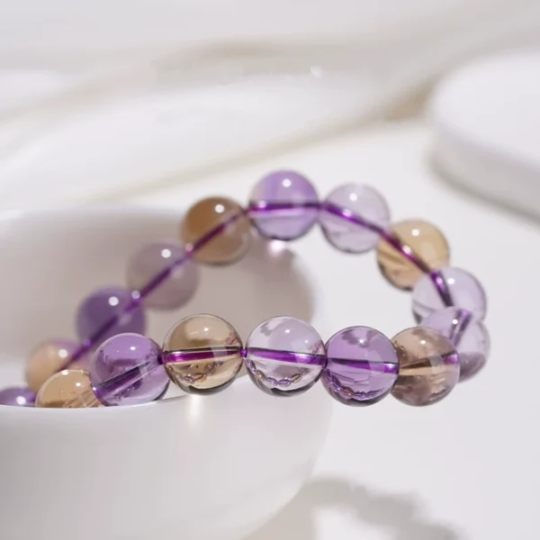 Close-up of crystal bead bracelet featuring purple and yellow gemstones