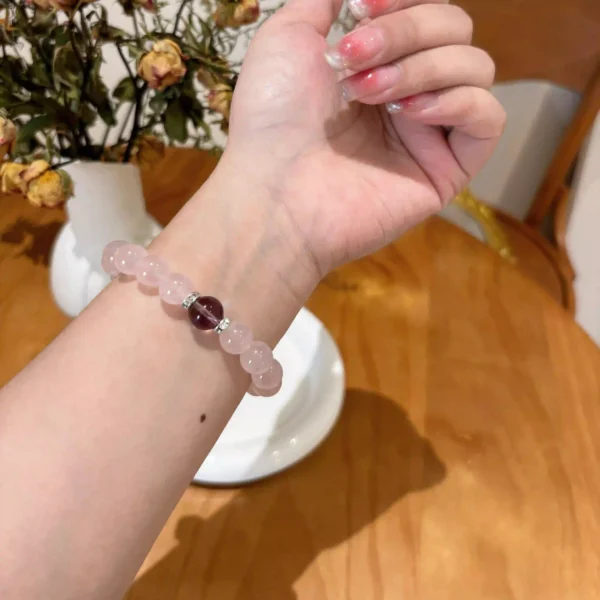 Woman wearing rose quartz and amethyst bracelet