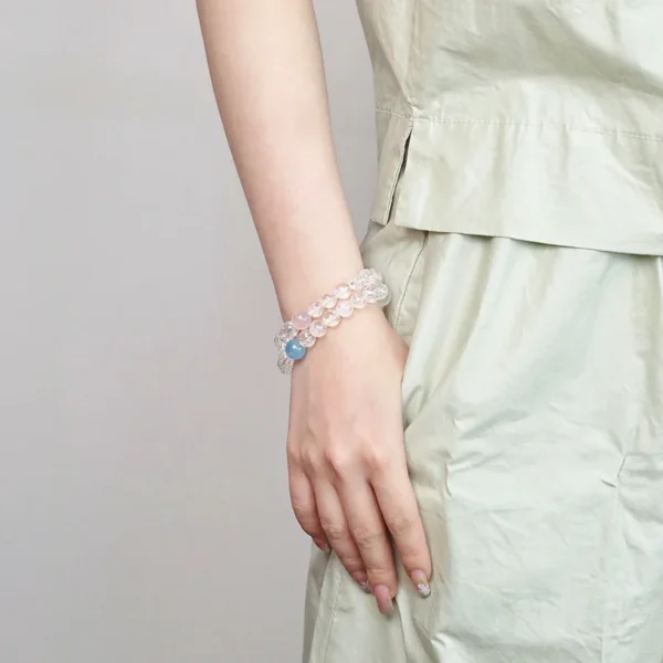 Wearing aquamarine and white asai crystal bracelet on wrist