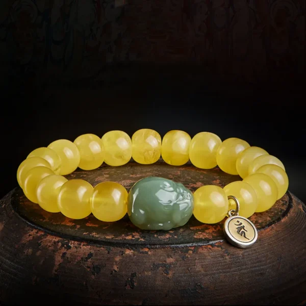 Beeswax Amber Feng Shui bracelet placed on a wooden background
