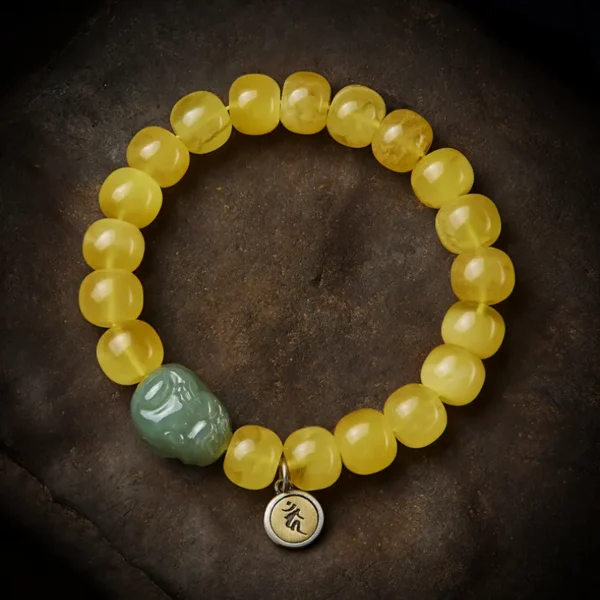 Beeswax Amber Hetian Jade Pixiu Bracelet closeup showing yellow beads and jade charm