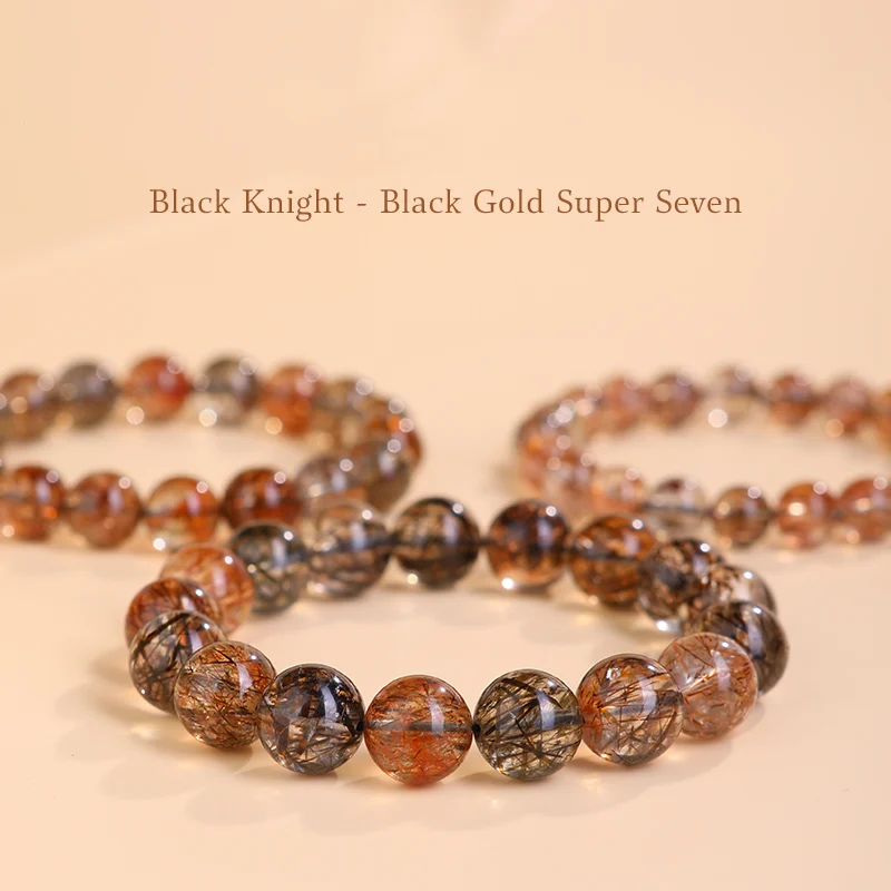 Black Gold Super Seven bracelets arranged on peach-toned background with text