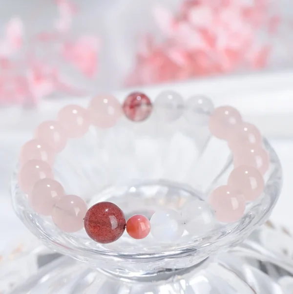 Healing bracelet made of pink and red crystals against a romantic backdrop