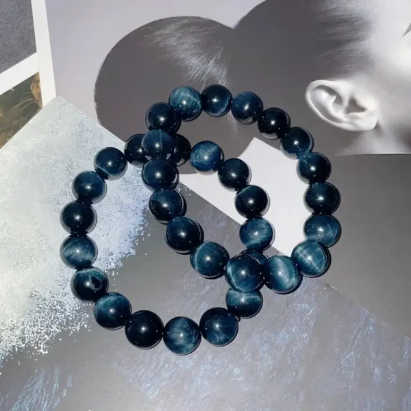 Blue Tiger Eye Bracelet with golden sheen, displayed on magazine background