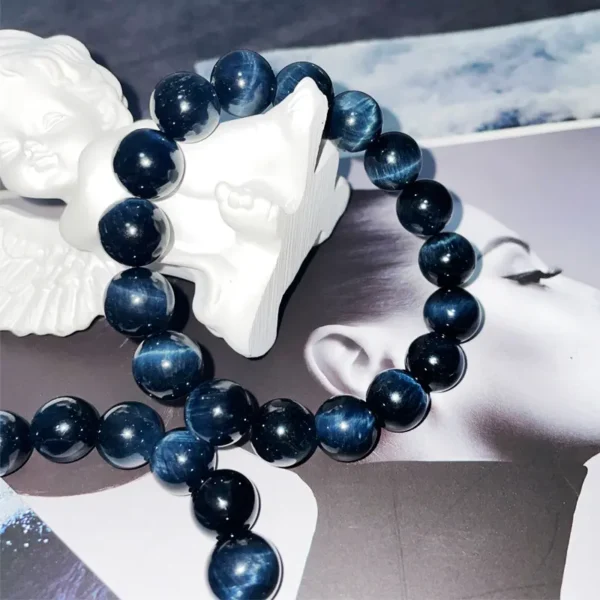Blue Tiger Eye bracelet draped over a white angel statue