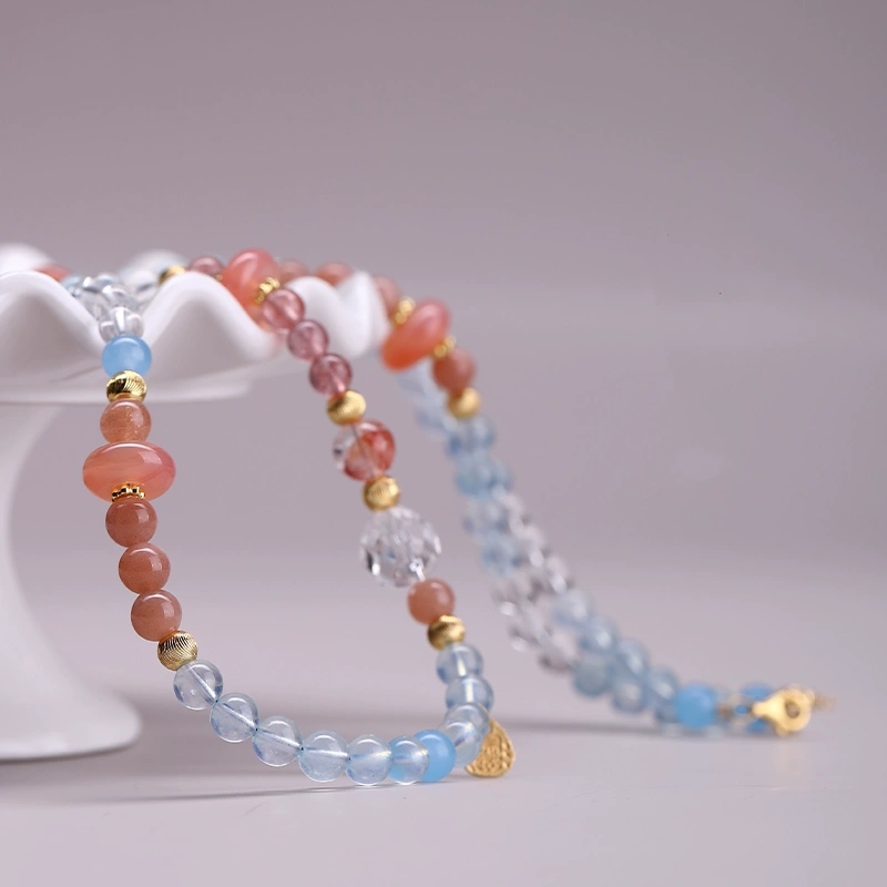 Aquamarine and Strawberry Quartz wrap bracelet close-up with gentle lighting