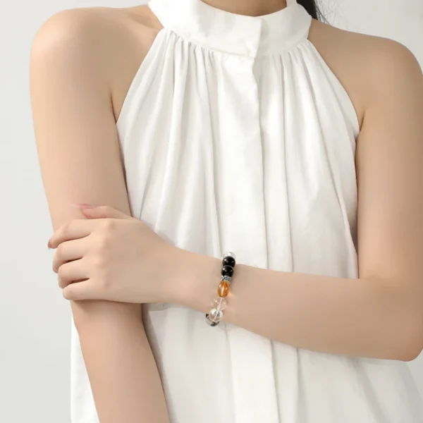 Woman in white dress wearing Brave Light bracelet
