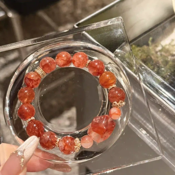 Red agate bracelet photographed through a transparent glass frame