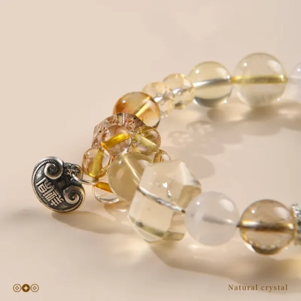 Close-up view of golden crystal beads with fortune charm