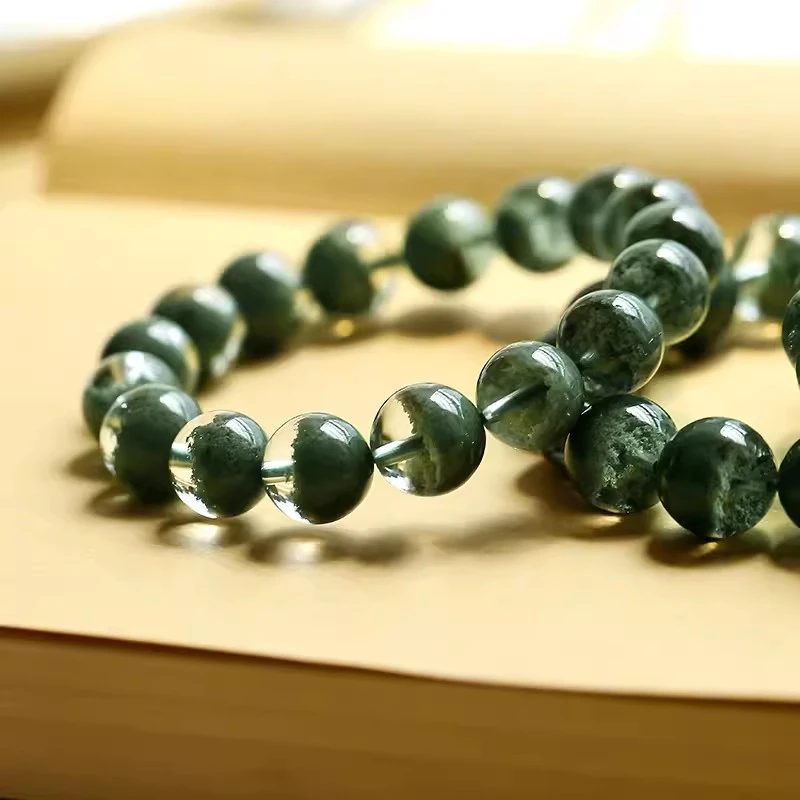 Close-up of green phantom quartz beads showing inner inclusions