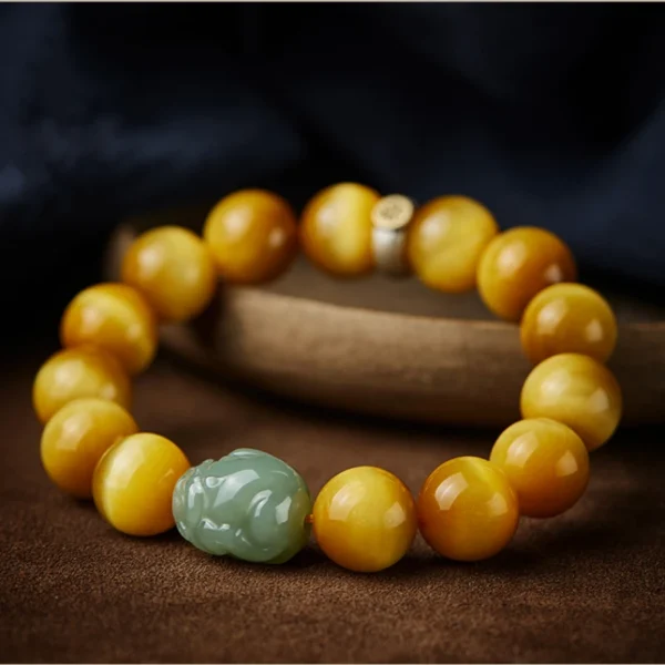 Detailed view of Hetian Jade Pixiu charm on Yellow Tiger Eye bracelet with 925 silver zodiac charm