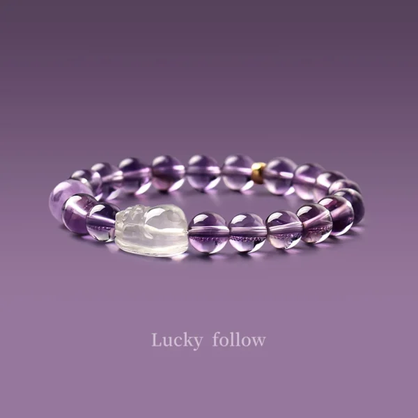 Amethyst Pixiu crystal bracelet with clear quartz charm on purple background