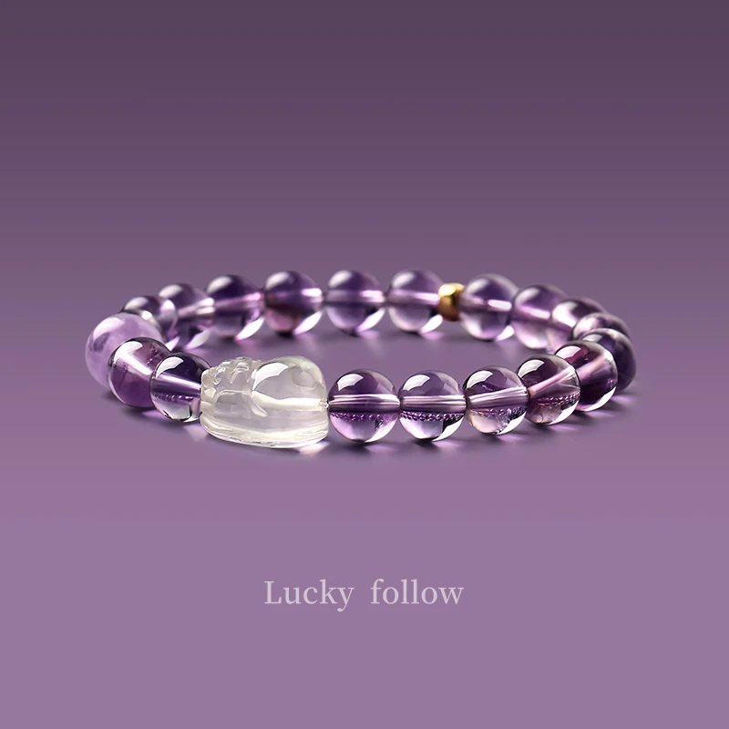 Amethyst Pixiu crystal bracelet with clear quartz charm on purple background