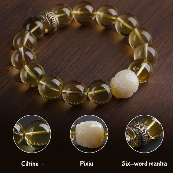 Close-up of citrine and jade Pixiu with mantra ring detail