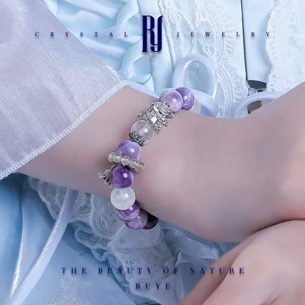 Model wearing purple crystal bracelet with silver butterfly design