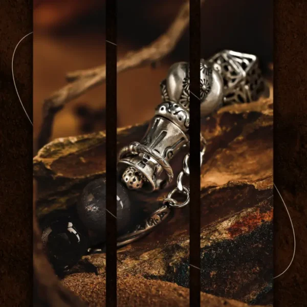 Macro shot of silver clasp and charm on men’s handmade bracelet