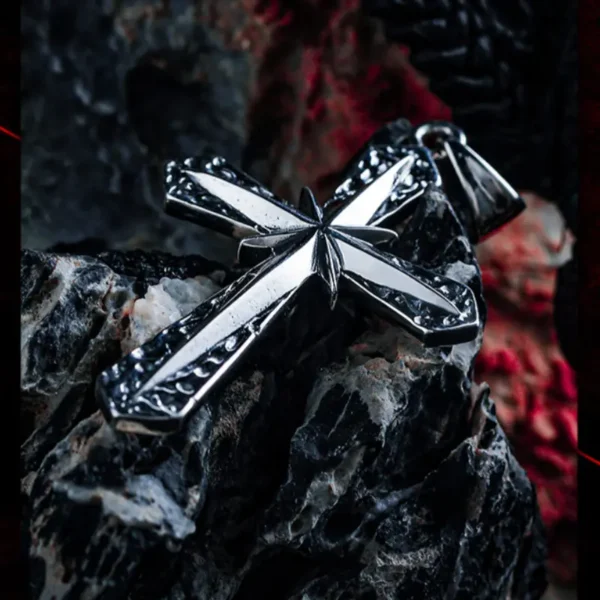 Sterling silver cross pendant on black and red rock