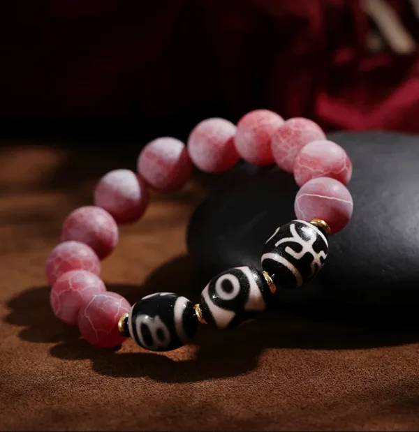 Guardian Flow bracelet with pink cracked agate and three-eye Dzi bead