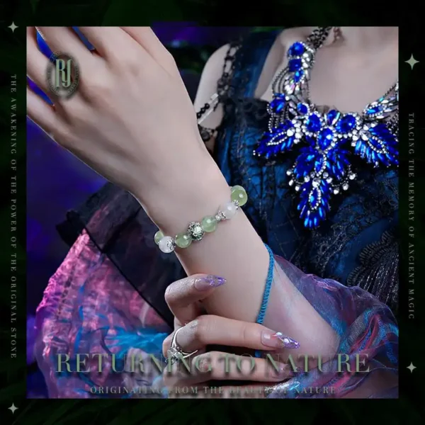 Prehnite and White Ghost healing bracelet on woman’s wrist with floral dress