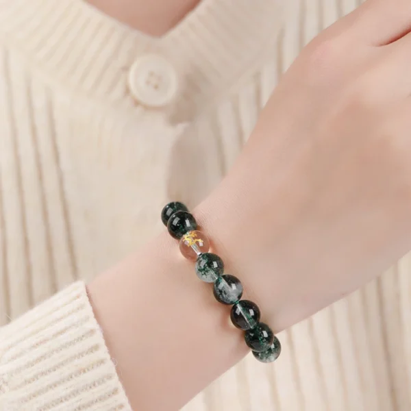Woman wearing green phantom Chinese zodiac energy bracelet