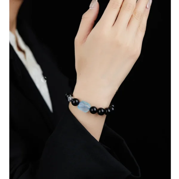 Courage Crystal Bracelet Styled on Wrist with Black Outfit