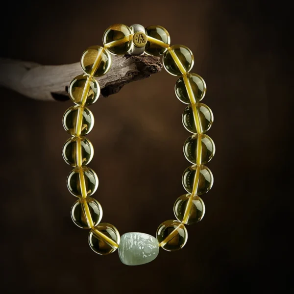 Feng Shui Citrine bracelet featuring Hetian Jade Zodiac charm on dark background
