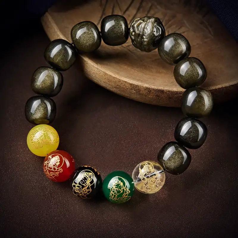 Obsidian Zodiac Bracelet with Five Wealth Buddhas on dark wooden background