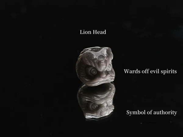 Close-up of silver obsidian lion head bead