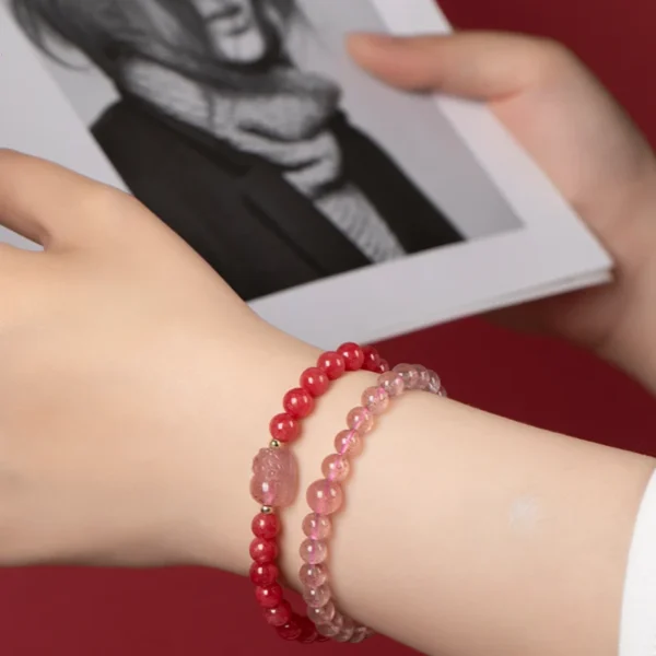 Model hand wearing pink crystal bracelets – stylish love protection