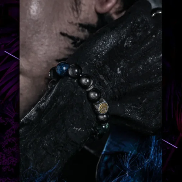 Male model wearing obsidian bracelet with silver beast charm
