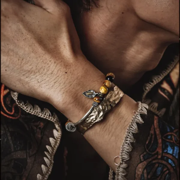 Model wearing the GUXI bracelet with tiger eye beads and silver bug charm