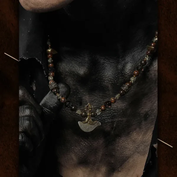 Close view of Asura God necklace worn over dark skin with gothic styling