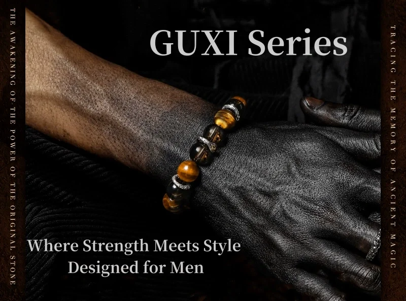 A man's wrist wearing a bold tiger’s eye and obsidian crystal bracelet from the GUXI Series, with text "Where Strength Meets Style – Designed for Men" over a dark background