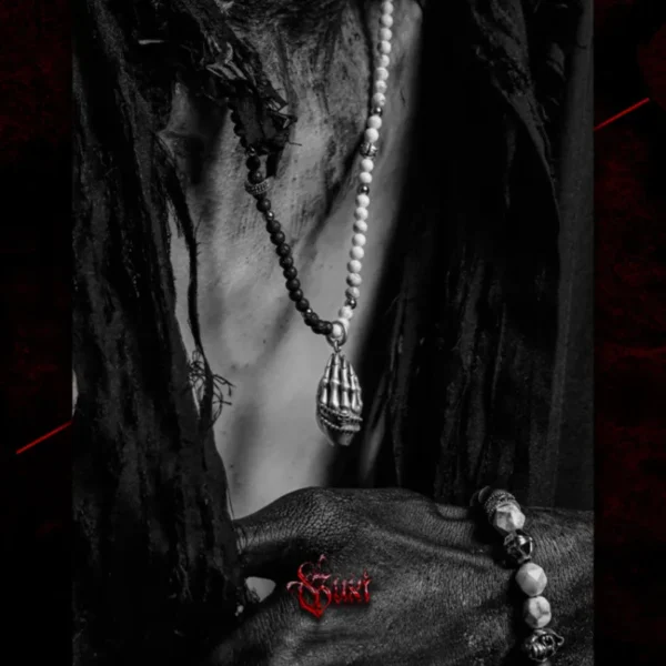 Close view of GUXI lava stone and howlite necklace worn on male model