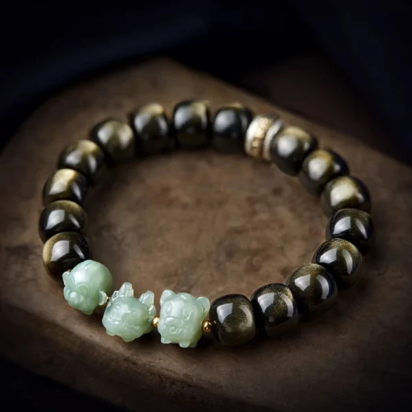 Close-up of golden obsidian beads in Zodiac Guardian Bracelet, highlighting natural luster and metallic reflections