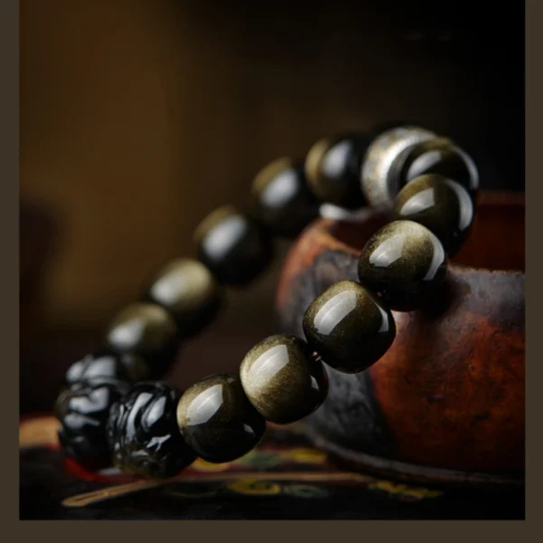 Model wearing Golden Obsidian bracelet with triple zodiac charms and mantra bead