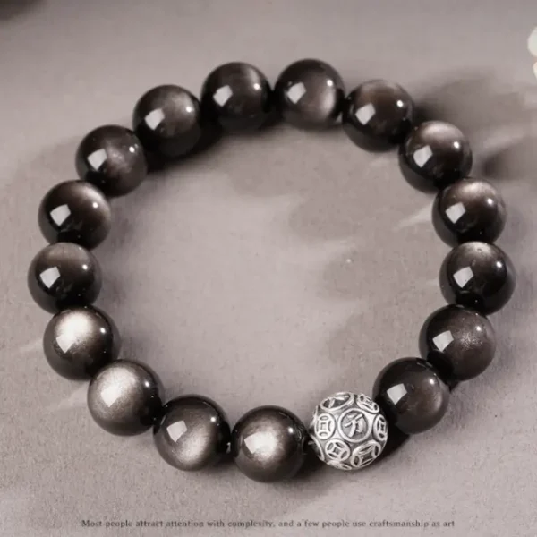 Healing crystal bracelet made of silver obsidian and silver charm