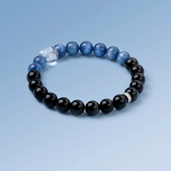 Kyanite, Obsidian and Quartz healing bracelet on light blue background