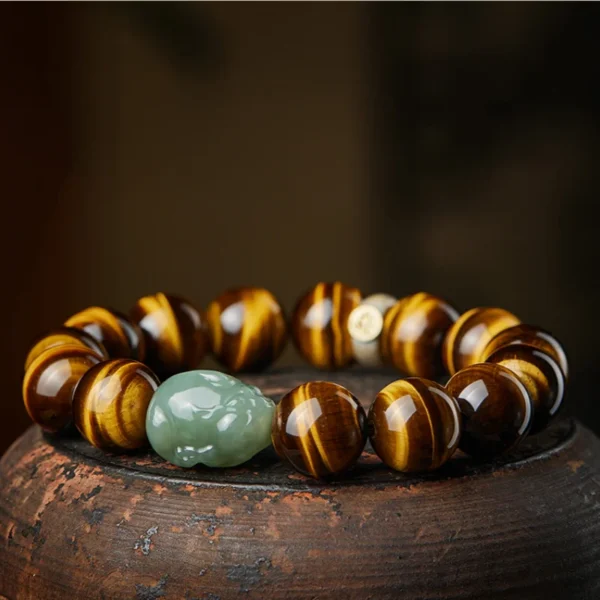 Bracelet composed of golden Yellow Tiger Eye beads, green Hetian Jade Pixiu, and a silver zodiac charm engraved with Chinese symbols.