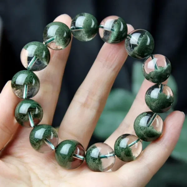 Green ghost quartz bracelet held in hand