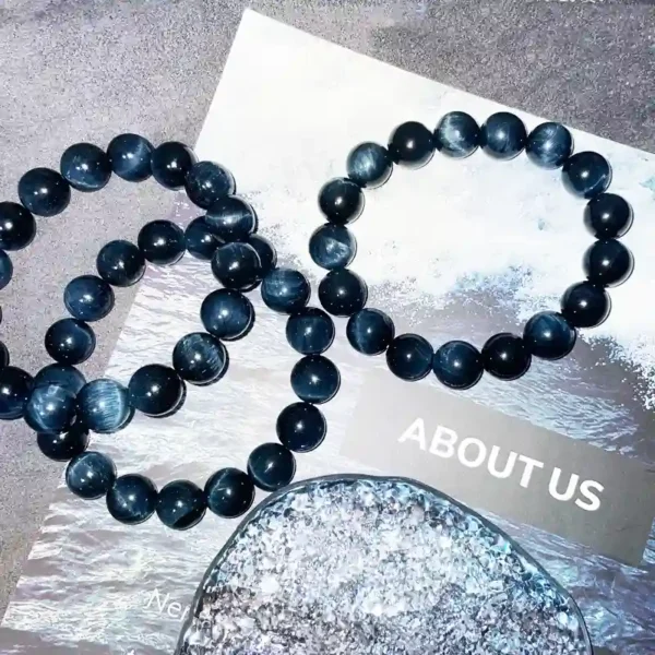Three Blue Tiger Eye bracelets layered on a wave-themed background