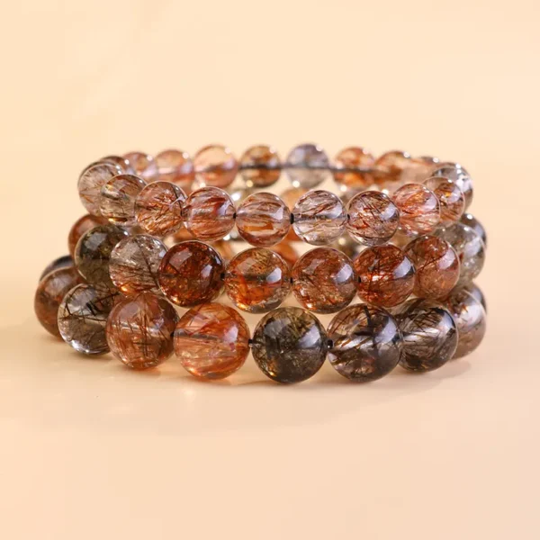 Stack of multiple Black Gold Super Seven bracelets for healing energy