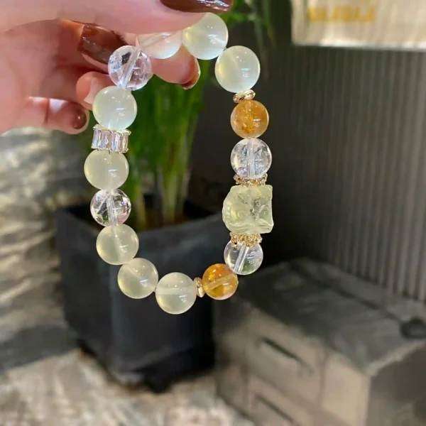 Handmade Lion Dance crystal bracelet held up to show design