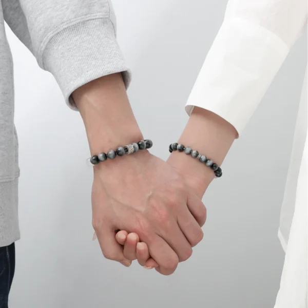 Couple holding hands with Yin Radiance bracelets