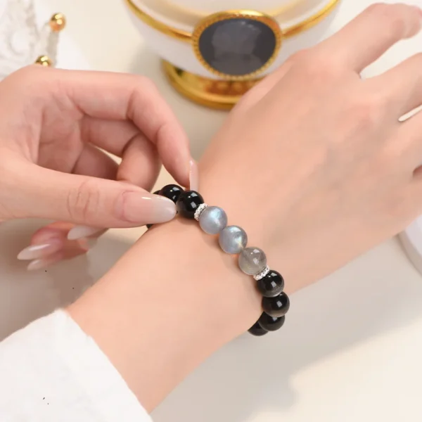Bracelet on wrist – moonstone and silver obsidian