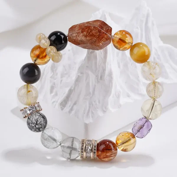 Crystal bracelet with faceted gemstones and tiger's eye on mountain-like backdrop