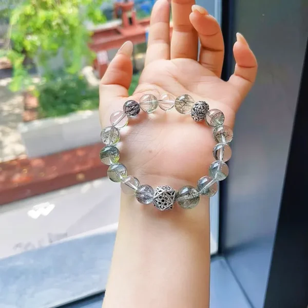 Mystic Grove bracelet in hand near window light
