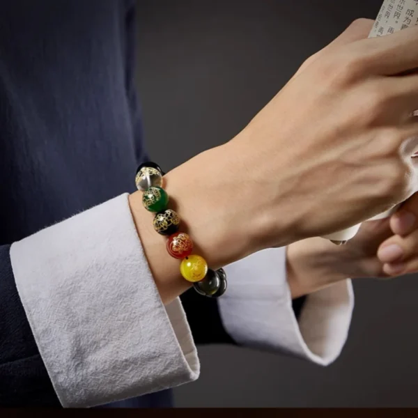 Model wearing Obsidian Zodiac Bracelet with Five Buddhas